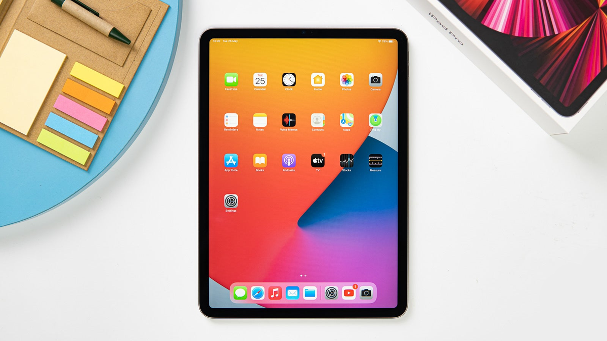 iPad Pro (2021) on a white table with its retail box visible on the top right corner.