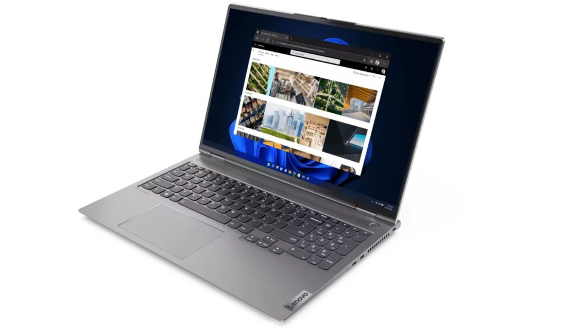 A silver Lenovo laptop is open, displaying the OneDrive for Business interface in a web browser on the Windows 11 operating system.